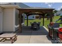 The home's backyard features a covered patio gazebo with dining furniture, grilling area, and great outdoor potential at 864 Pointe Andrews Dr, Concord, NC 28025