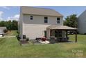 This large backyard is equipped with a gazebo with patio furniture, garden beds, and a well-manicured lawn at 864 Pointe Andrews Dr, Concord, NC 28025