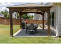 Backyard patio area features a gazebo with patio furniture, providing an outdoor dining and relaxation space at 864 Pointe Andrews Dr, Concord, NC 28025
