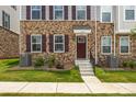 Welcoming front exterior featuring brick accents and a neatly landscaped yard at 9921 Oaklawn Nw Blvd, Huntersville, NC 28078