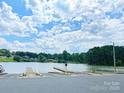 Paved boat ramp leading to a serene lake with scenic views and clear blue skies on a sunny day at 109 Joe Teague Rd, Hickory, NC 28601