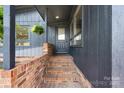 Home entrance with brick stairs leading to the front door and green plants hanging down at 109 Joe Teague Rd, Hickory, NC 28601