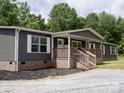 Inviting home with cozy front porch, brick foundation, and well-maintained landscaping at 1856 Kemp Cir, Shelby, NC 28152