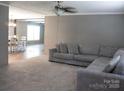 Spacious living room with plush carpeting and a comfortable sectional sofa at 1856 Kemp Cir, Shelby, NC 28152
