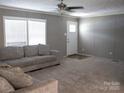 Bright living room features large windows and a comfortable gray sectional at 1856 Kemp Cir, Shelby, NC 28152