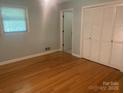 Bedroom with hardwood floors, closet, and window offering natural light at 204 Biltmore Ave, China Grove, NC 28023