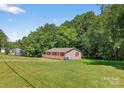 Charming single-story home with a spacious wooden deck and red accents at 2611 Dallas Stanley Hwy, Stanley, NC 28164