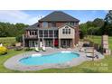 Expansive backyard with a large pool, multiple seating areas, and an outdoor kitchen, ideal for entertaining guests at 330 Waters Rd, Salisbury, NC 28146