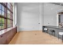 Bright living space with light wood floors, high ceilings, oversized windows and counter seating at 715 N Graham St # 207, Charlotte, NC 28202