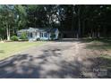 Charming white house featuring a spacious driveway and a large carport at 1257 Reese Roach Rd, Rock Hill, SC 29730
