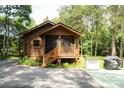 View of charming cabin with log siding and a covered porch at 164 Pleasant Creek Dr, Cleveland, NC 27013