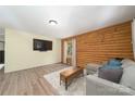Inviting living room with hardwood flooring, wood-paneled accent wall, and comfortable seating at 164 Pleasant Creek Dr, Cleveland, NC 27013