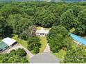 Aerial view of the house nestled within a densely wooded area, offering privacy at 222 Laramie Dr, Stanley, NC 28164