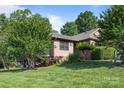 This property features a well-maintained lawn with mature trees and shrubbery, with a single-story home constructed with brick and wood at 2680 Heavens Ct, Fort Mill, SC 29715