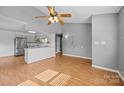 Open floor plan with wood floors leads from a spacious living area into the kitchen, creating an inviting, modern atmosphere at 2680 Heavens Ct, Fort Mill, SC 29715