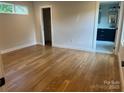 Cozy bedroom with hardwood floors and ample natural light from a high privacy window at 3049 Reid Ave, Charlotte, NC 28208