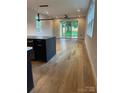 Bright open-concept living space with hardwood floors, modern lighting, and access to the backyard at 3049 Reid Ave, Charlotte, NC 28208