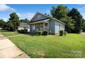 Single-story house with green lawn and trimmed bushes on a sunny day, showcasing simple charm at 404 Community St, Rock Hill, SC 29730