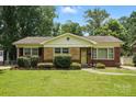 Charming single-story home featuring a manicured lawn, brick accents, and a classic design at 5126 Unaka Ave, Charlotte, NC 28205