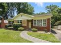 Lovely single-story home with a neatly landscaped front yard, brick exterior, and a welcoming walkway at 5126 Unaka Ave, Charlotte, NC 28205