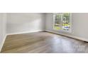 Bright bedroom featuring wood flooring and a view of the outdoors at 609 Bilmark Ave, Charlotte, NC 28213
