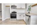 Modern kitchen features stainless steel appliances and white cabinets at 609 Bilmark Ave, Charlotte, NC 28213