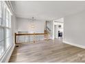 Inviting living room with hardwood floors, stairs, and abundant natural light at 609 Bilmark Ave, Charlotte, NC 28213