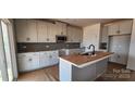 Modern kitchen with stainless steel appliances, gray cabinets, and island at 638 Amberjack Pl # 76, York, SC 29745