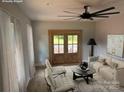 Bright living room featuring light grey walls, wood floors, large double doors, and staged furniture at 908 30Th Avenue Nw Dr # 2, Hickory, NC 28601