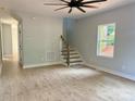 Bright open-concept living room featuring light grey walls, stairs, wood floors, and large window at 908 30Th Avenue Nw Dr # 2, Hickory, NC 28601