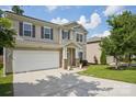Charming two-story home featuring a two-car garage, landscaped yard, and inviting front porch at 10303 Dominion Village Dr, Charlotte, NC 28269