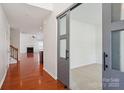 Spacious living room with hardwood floors, a fireplace, and modern sliding doors at 10303 Dominion Village Dr, Charlotte, NC 28269