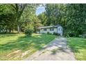 Charming single-story home, surrounded by mature trees and a well-maintained yard at 1048 Shenandoah Dr, Gastonia, NC 28052