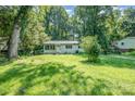 Charming single-story home with brick facade, black shutters and a lush green front yard at 1048 Shenandoah Dr, Gastonia, NC 28052