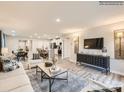 Open-concept living room featuring a cozy sofa, stylish decor, and a seamless flow to the kitchen at 109 Oconee Trl, Statesville, NC 28625