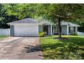 Charming one-story home with a well-manicured lawn and inviting front porch with white columns and attached two car garage at 13517 Silver King Ct, Huntersville, NC 28078