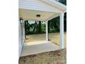 Covered patio perfect for outdoor lounging and entertaining with white pillars and a view of the yard at 1683 Interstate View Dr, Gastonia, NC 28052