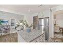 The kitchen features granite countertops and stainless steel appliances with an open view to the living and dining rooms at 6017 Santee River Way # 40, Belmont, NC 28012