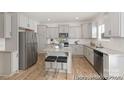 Bright kitchen features stainless steel appliances, granite counters, and island with seating at 6032 Santee River Way # 50, Belmont, NC 28012