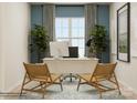 Modern home office featuring white desk, decorative plants, woven chairs, and natural light at 6400 Fairfax Ct, Maiden, NC 28650