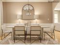 Stylish dining room showcases a modern table, chandelier, with accent mirror and patterned rug at 6448 Fairfax Ct, Maiden, NC 28650