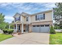 Inviting two-story home with manicured lawn, brick and siding exterior, and attached two-car garage at 902 Silverberry St, Gastonia, NC 28054