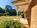 View of the front porch showing brick columns and a hanging light fixture at 125 Circle Dr, Mount Holly, NC 28120