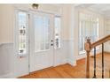 Bright entryway featuring a front door, hardwood floors, and decorative trim at 1730 Townsend Ln, Rock Hill, SC 29730