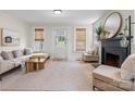 Bright living room with neutral decor, fireplace, large windows, and hardwood floors creating a cozy atmosphere at 2704 Kool Park Ne Rd, Hickory, NC 28601
