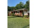Inviting ranch home featuring a charming front porch with ample seating and a well-kept lawn at 3085 Faith Rd, Salisbury, NC 28146
