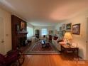 Cozy living room with a brick fireplace, hardwood floors, and neutral decor at 506 Hearne Farm Rd, Mount Gilead, NC 27306