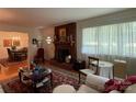 Comfortable living room featuring a brick fireplace, hardwood floors, and cozy seating at 506 Hearne Farm Rd, Mount Gilead, NC 27306