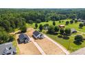 Aerial view of newly built homes on large lots surrounded by lush greenery at 1019 S Main St, Granite Quarry, NC 28146