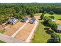 Aerial view featuring new homes, spacious lots, and natural wooded scenery at 1019 S Main St, Granite Quarry, NC 28146